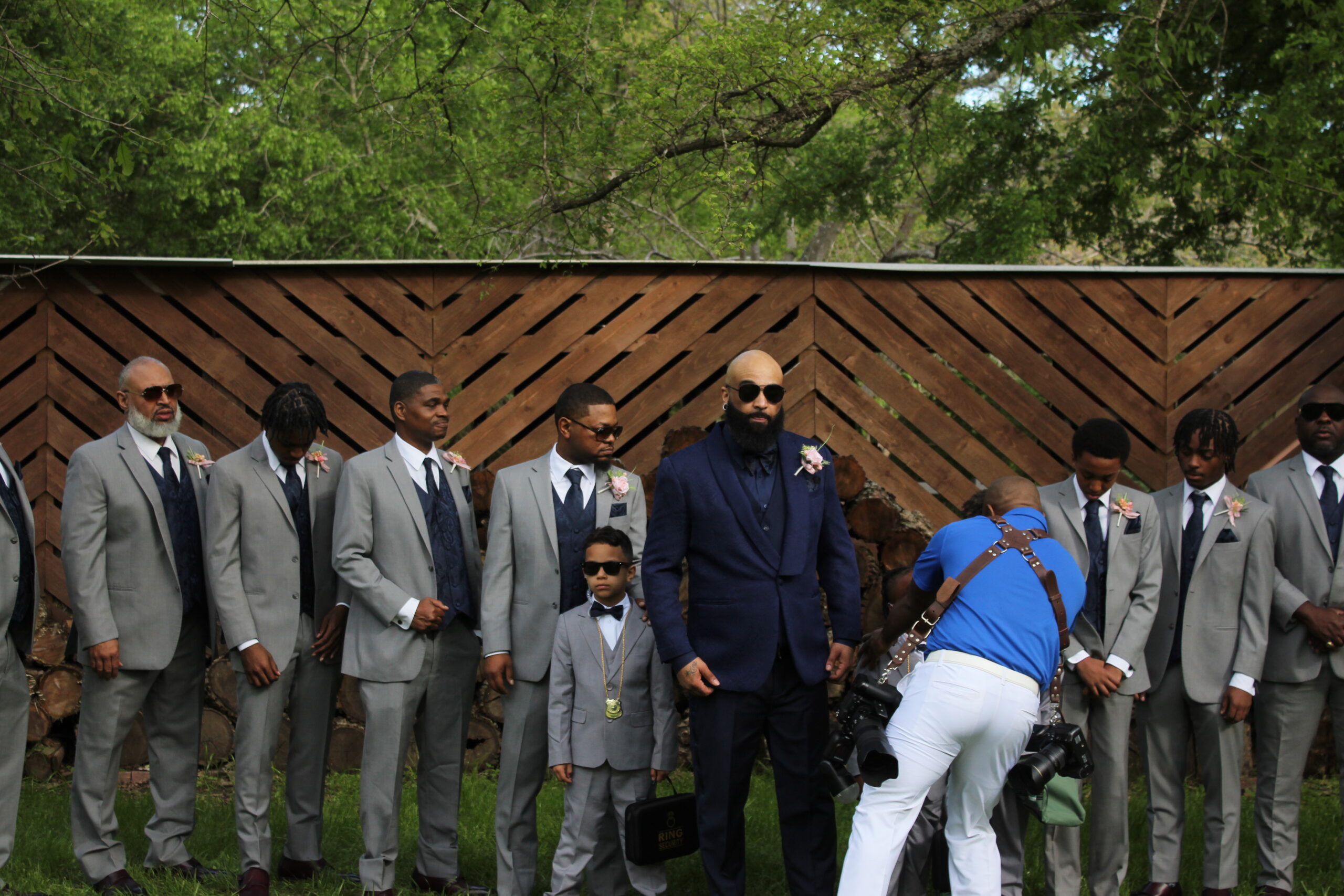 Groom and grooms being posed while at Arrowwood weddings and events